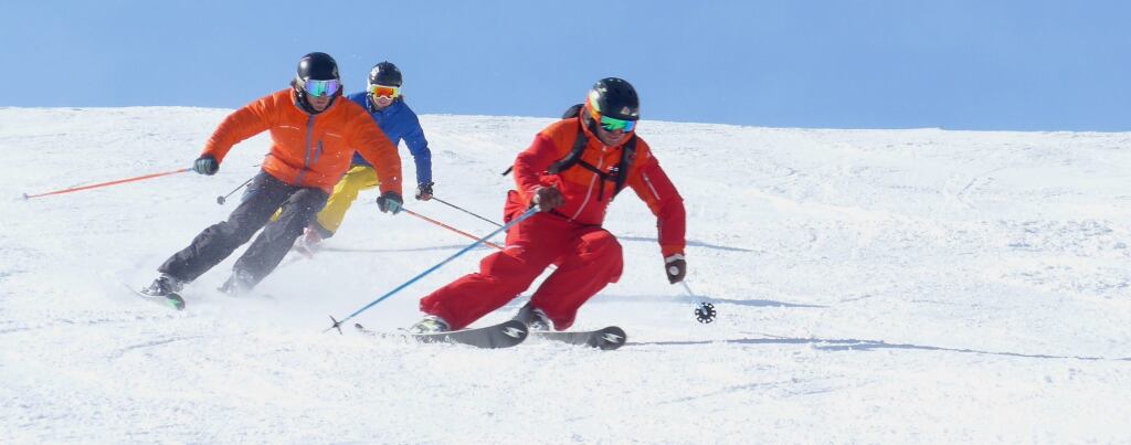 Skilehrer mit 2 Skischülern